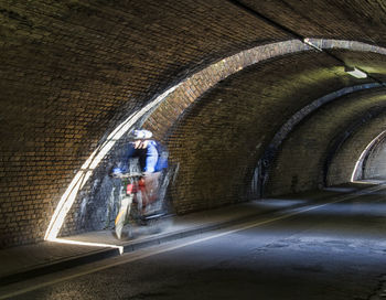 Blurred motion of man in tunnel