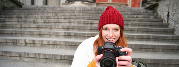 Portrait of young woman using mobile phone