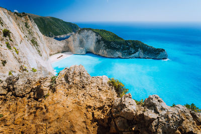 Scenic view of rocks in sea against sky