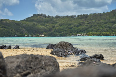 Rocks on beach against sky