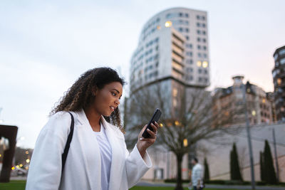 Man using mobile phone in city