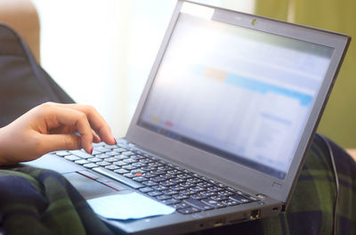 Midsection of man using mobile phone