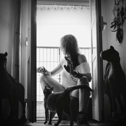 Woman sitting by window at home