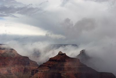 Scenic view of mountain against cloudy sky