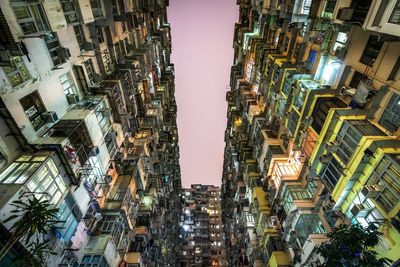 Low angle view of buildings in city at night