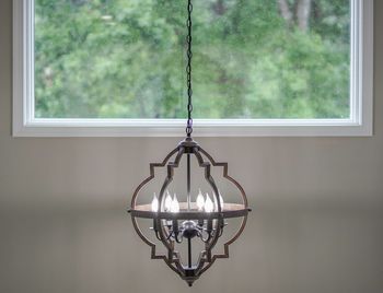 Close-up of electric lamp hanging at home