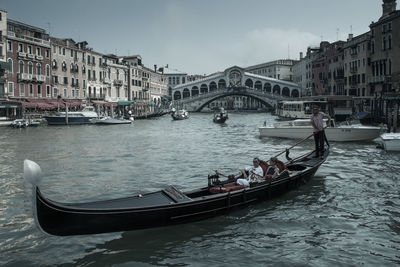 Boats in canal along buildings