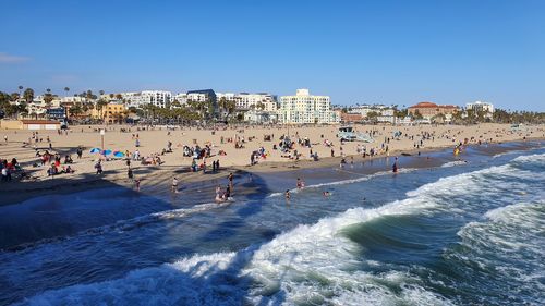 People on beach against clear sky, santa monica beach