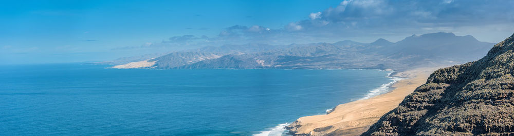 Panoramic view of sea and mountains against sky