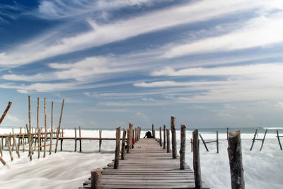 Wooden pier on sea against sky during winter