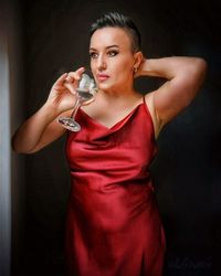 Beautiful woman drinking while standing at home