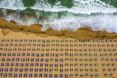 High angle view of lounge chairs at beach