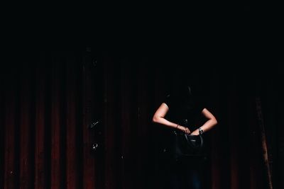 Woman holding purse at night