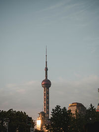 Oriental pearl tower shanghai angle view of buildings against cloudy sky