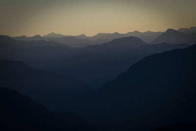 Scenic view of silhouette mountains against sky during sunset