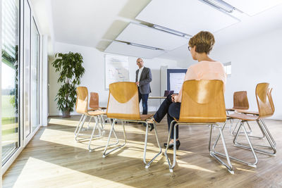 Rear view of people sitting on chair