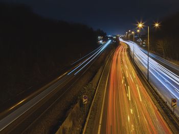 High angle view of light trails on road at night