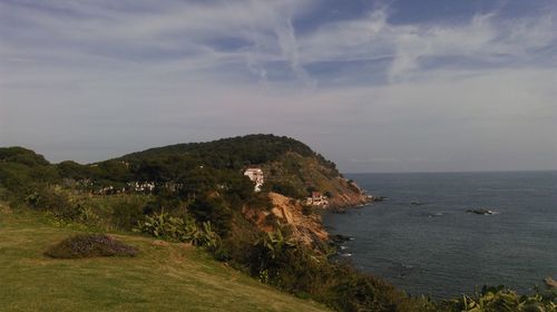 Scenic view of sea and mountains against sky