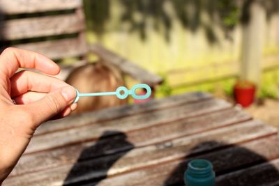 Cropped hand holding bubble wand