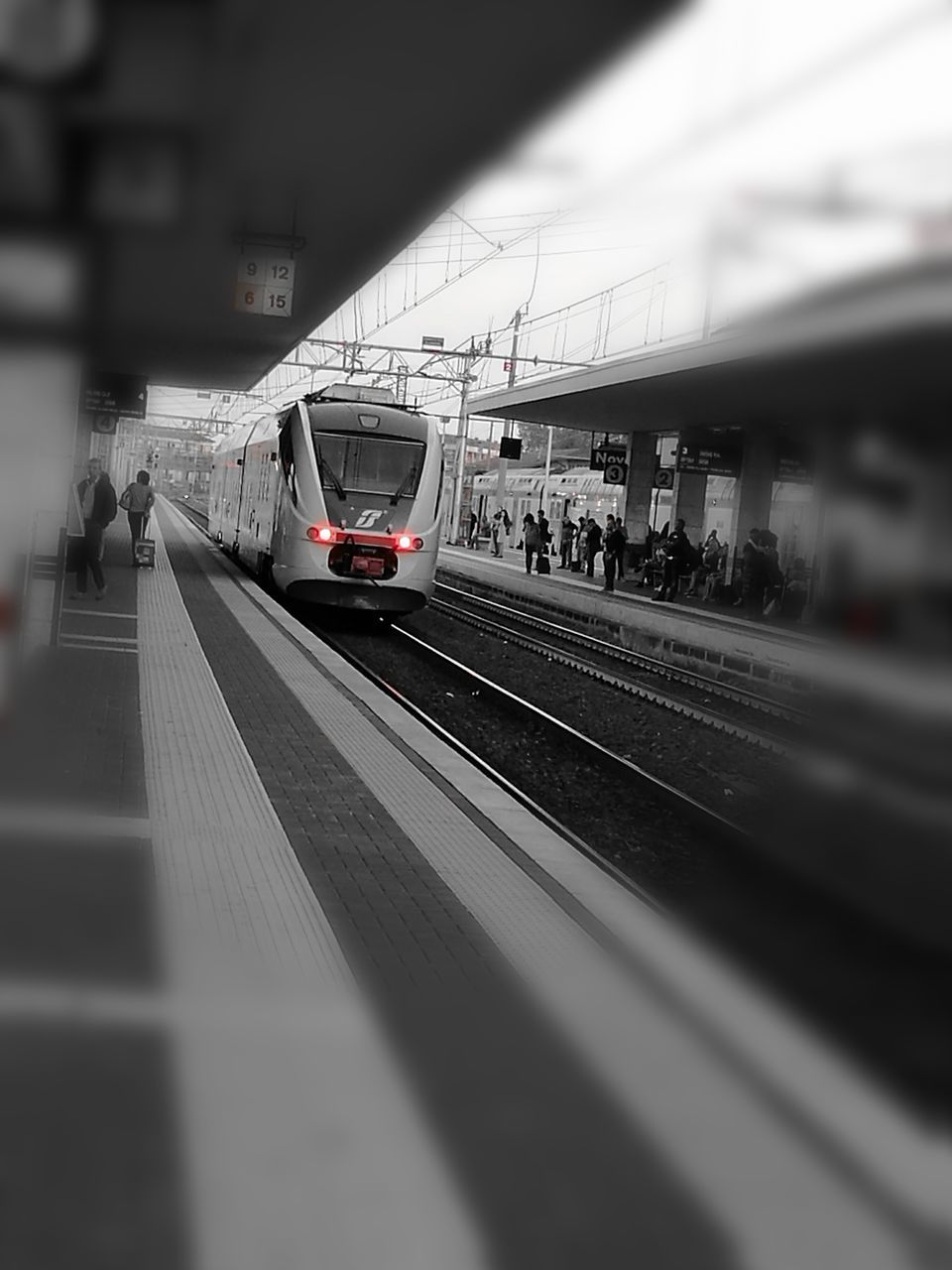 TRAIN ON RAILROAD STATION AGAINST SKY