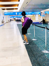 Full length of woman walking in airport