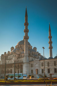 Exterior of new mosque against clear blue sky in city