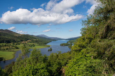 Scenic view of lake by trees against sky