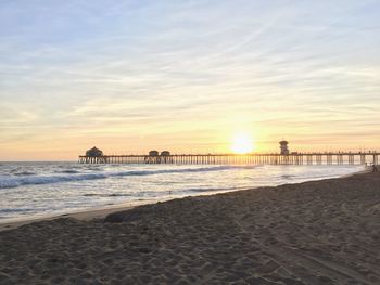 Scenic view of beach against sky during sunset