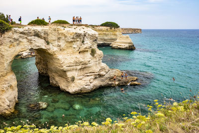 Rock formations in sea against sky