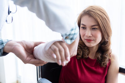 Portrait of a beautiful young woman holding hands