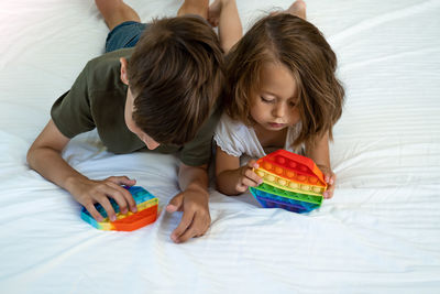 High angle view of mother and daughter on bed