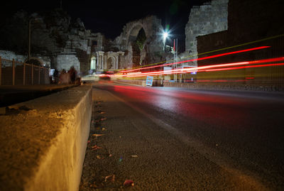 Light trails on road in city at night