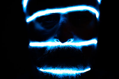 Close-up portrait of illuminated lighting equipment at night