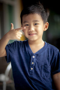 Portrait of cute boy gesturing