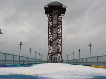 Low angle view of tower against sky during winter