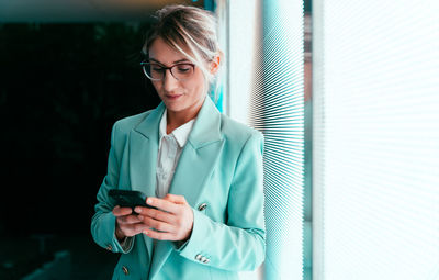 Portrait of young businesswoman using mobile phone