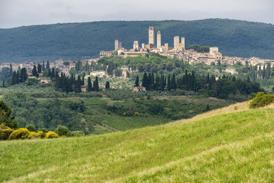 Panoramic view of trees and buildings against sky