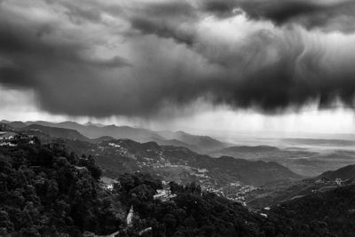Scenic view of mountains against cloudy sky