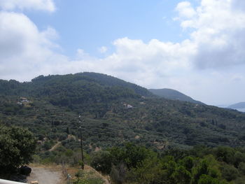 Scenic view of mountains against cloudy sky