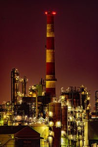 Illuminated cityscape against sky at night