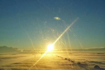 Scenic view of beach against clear sky during sunset
