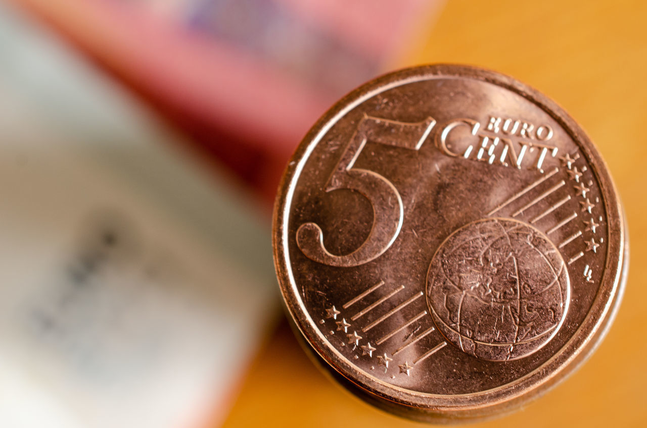 CLOSE-UP OF COINS ON METAL