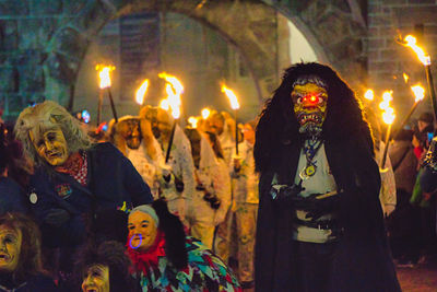 Group of people against illuminated fire at night