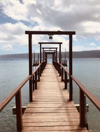 Pier over sea against sky