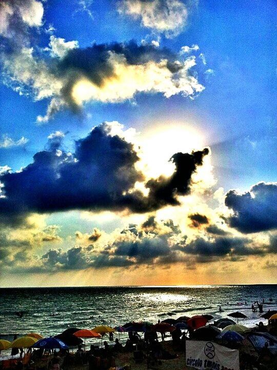 sea, horizon over water, sky, water, cloud - sky, scenics, beauty in nature, sunset, tranquil scene, beach, tranquility, cloud, cloudy, nature, shore, idyllic, blue, outdoors, dramatic sky, incidental people