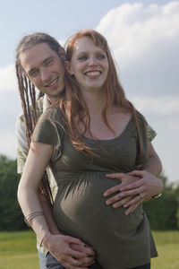 Portrait of a smiling young couple expecting baby