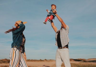 Full length of father with son standing on land