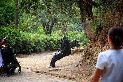 People sitting on tree