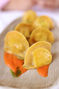 Close-up of orange slices in plate on table