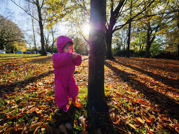 Girl standing on field during autumn